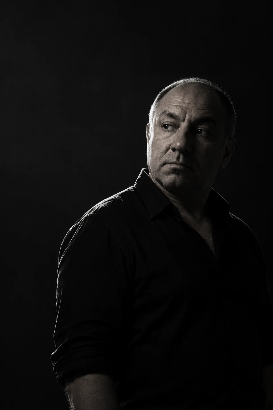 Black-and-white portrait of Ivaylo Peytchev against a dark background